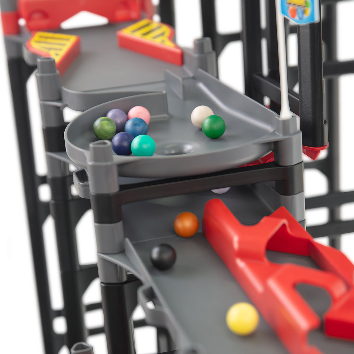 IMR Speedway Redline funnel track piece close-up with colorful marbles gathering before dropping through to lower level