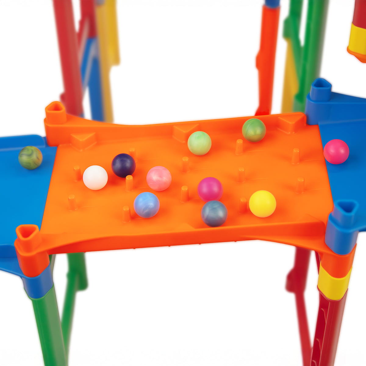 IMR Speedway Overdrive orange impact zone peg section close-up with colorful marbles scattered across the surface