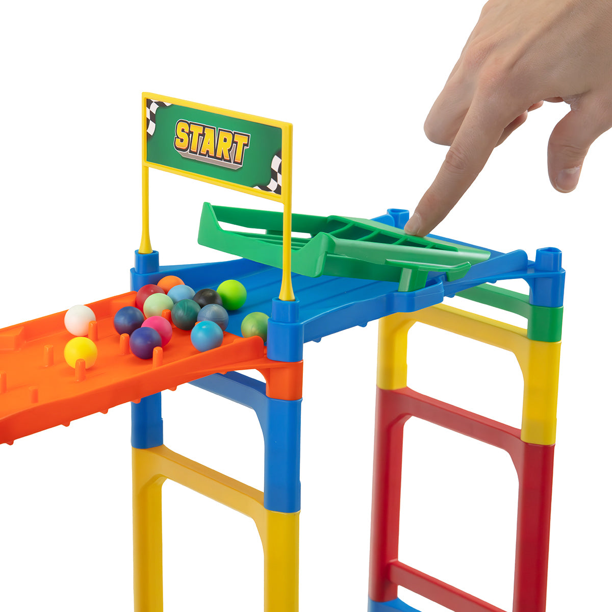 IMR Speedway Overdrive starting block with hand pressing marble release gate, start flag, and colorful marbles lined up on orange ramp