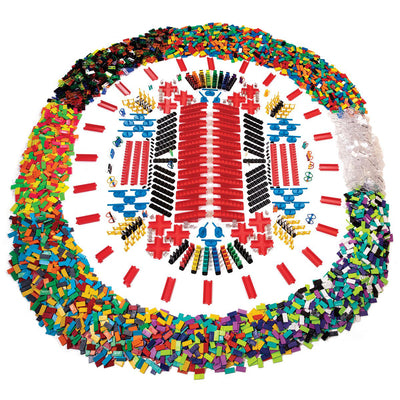 Atwood Toys Bulk Dominoes Ultra Super Galactic Kit wide shot showing 6,500+ pieces arranged in a circular display with multi-color and clear dominoes, red rapid tracks, blue spinners, and accessories