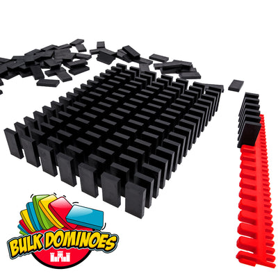 Grid of upright solid black Bulk Dominoes Black Pro Dominoes neatly arranged in rows, with a loose pile behind and a red plastic domino stacker tray holding a curved line of black dominoes.