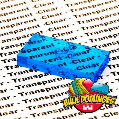 Close-up of a single translucent Bulk Dominoes Clear Blue Pro Domino resting on printed text, with the words showing through the see-through blue tile to highlight its clarity.