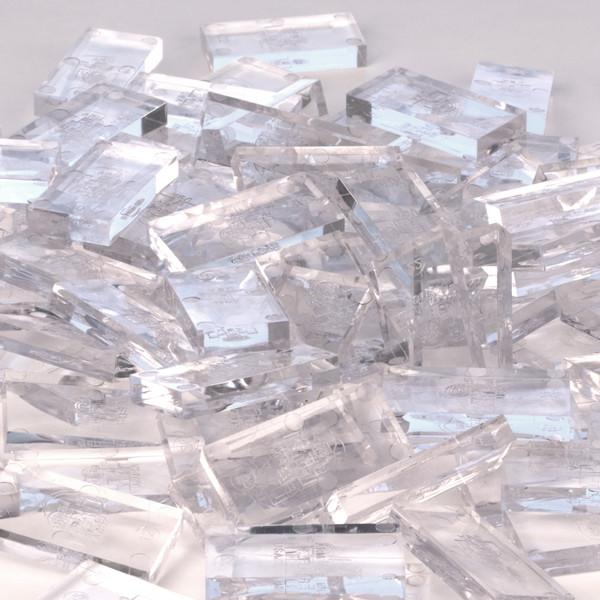 Bulk Dominoes closeout dominoes close-up of clear transparent Pro Dominoes piled together showing light refraction through the plastic