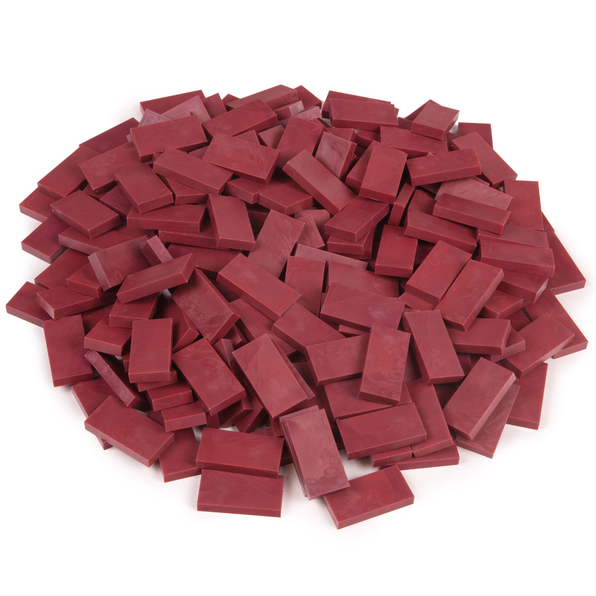 Bulk Dominoes Pomegranate Pro Dominoes from Atwood Toys, a top-down pile of deep maroon pomegranate red full-weight toppling dominoes for chain reactions and domino art.