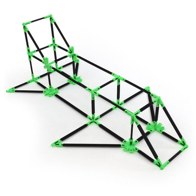 A spaceship built with Inventix, featuring an elongated angular frame with a raised cockpit section at one end, swept structural supports, and a tapered nose, made from black rods and green connectors.