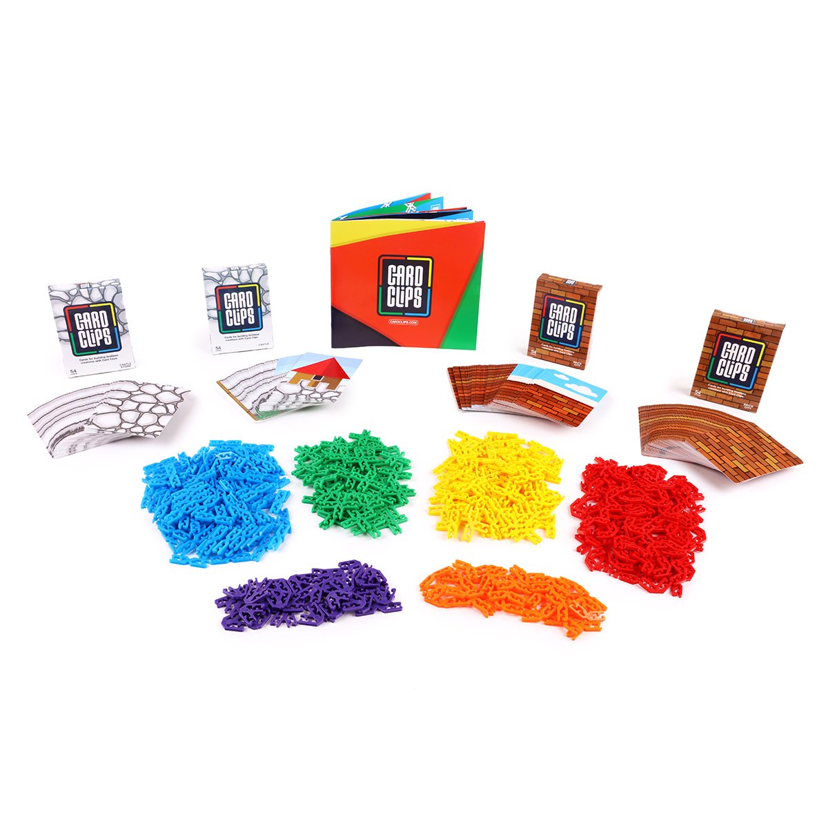 Super Construction Kit from Atwood Toys, piles of blue, green, yellow, red, purple, and orange Card Clips connectors with printed building cards and an instruction booklet for joining cards into towers, bridges, and 3D structures.