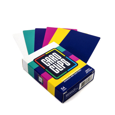 Building Cards Artisan deck from Atwood Toys, a fan of printed building cards in white, teal, purple, magenta, yellow, and navy beside the Card Clips box for constructing card towers and 3D structures.