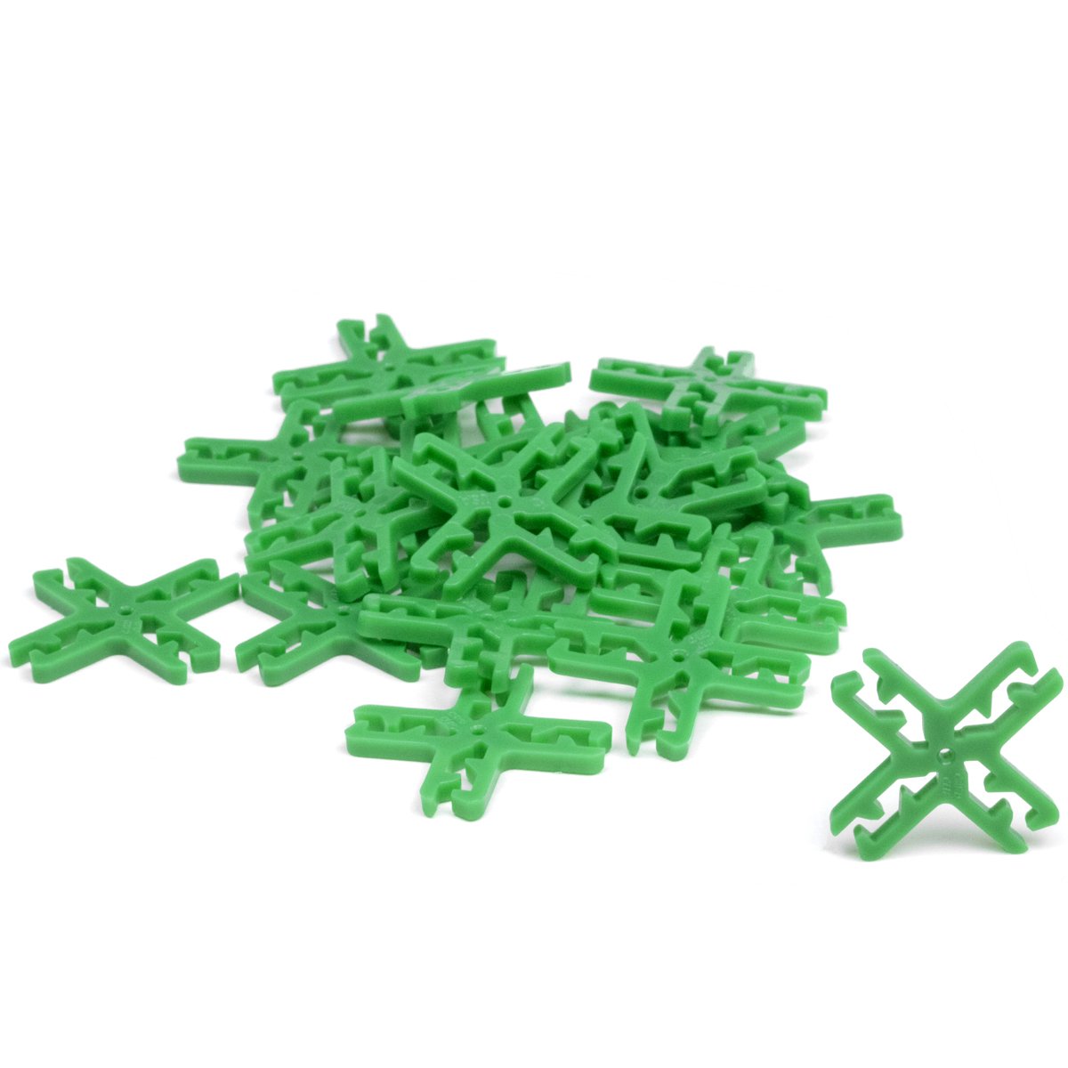 Card Clips 4-way connectors from Atwood Toys, a scattered pile of green cross-shaped plastic clips that link trading and playing cards into towers, bridges and 3D structures.